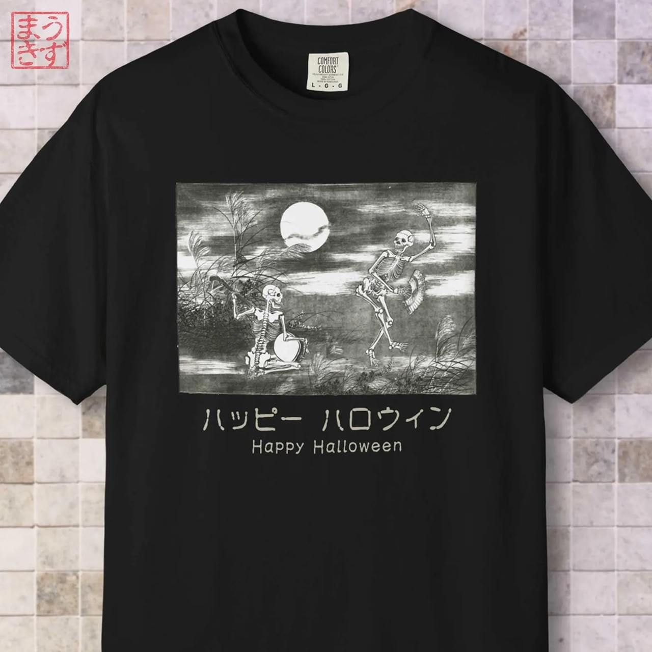 A black t-shirt features an illustration of two skeletons dancing under a full moon amidst grass and bare trees, and text below.
